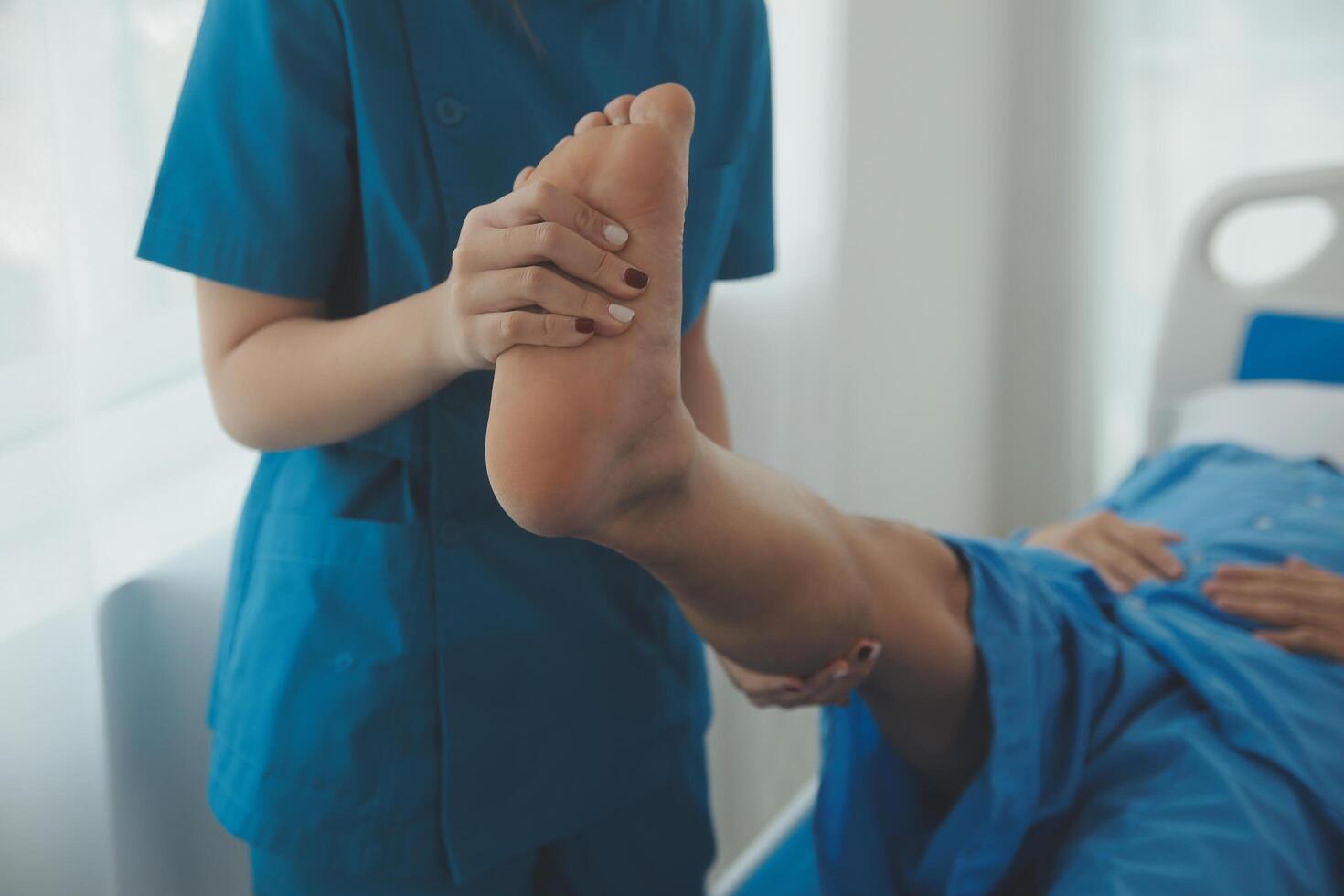 Physical therapists work with patients in close-up clinics. The concept of rehabilitation of physical health, the doctor gives advice to the patient. Ankle problems and muscle injuries photo