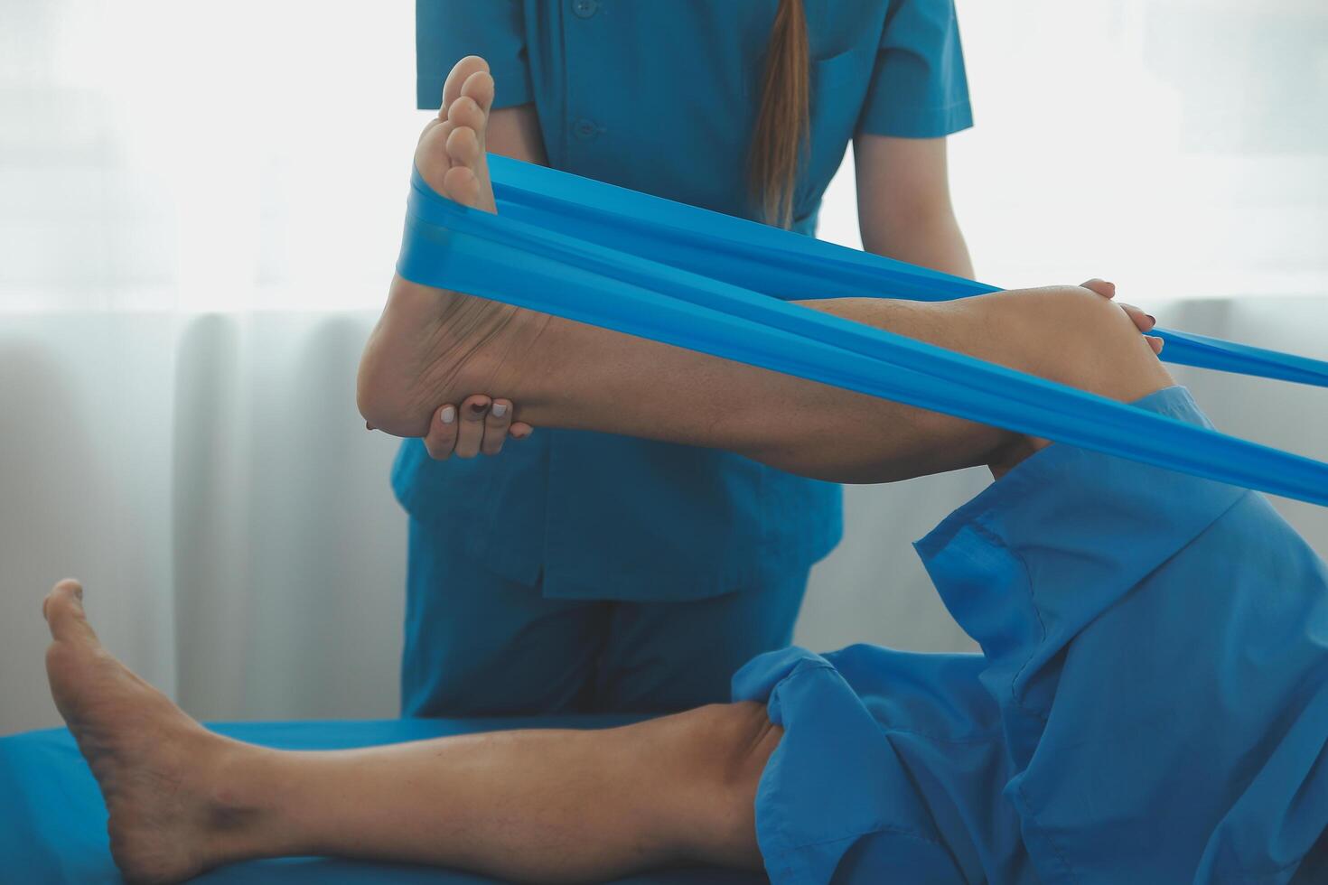 Physical therapists work with patients in close-up clinics. The concept of rehabilitation of physical health, the doctor gives advice to the patient. Ankle problems and muscle injuries photo