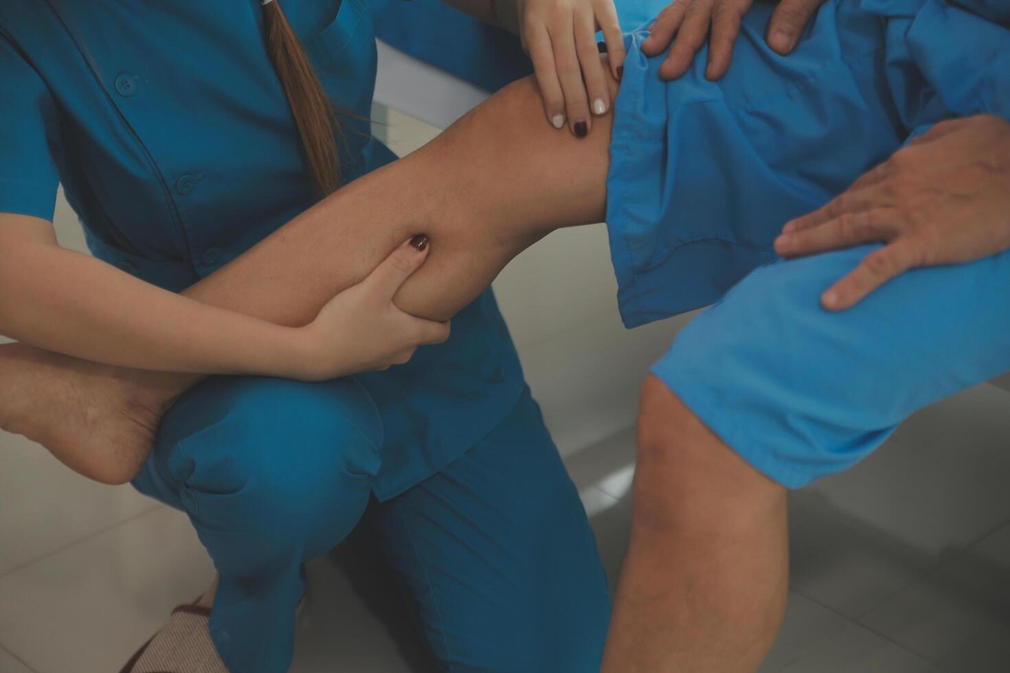 Physical therapists work with patients in close-up clinics. The concept of rehabilitation of physical health, the doctor gives advice to the patient. Ankle problems and muscle injuries photo