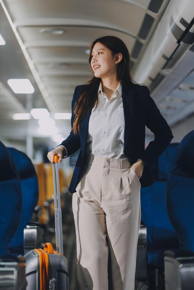 Asian young women passenger walk in airport terminal to boarding gate. Attractive beautiful female tourist friends feeling happy and excited to go travel abroad by airplane for holiday vacation trip. photo