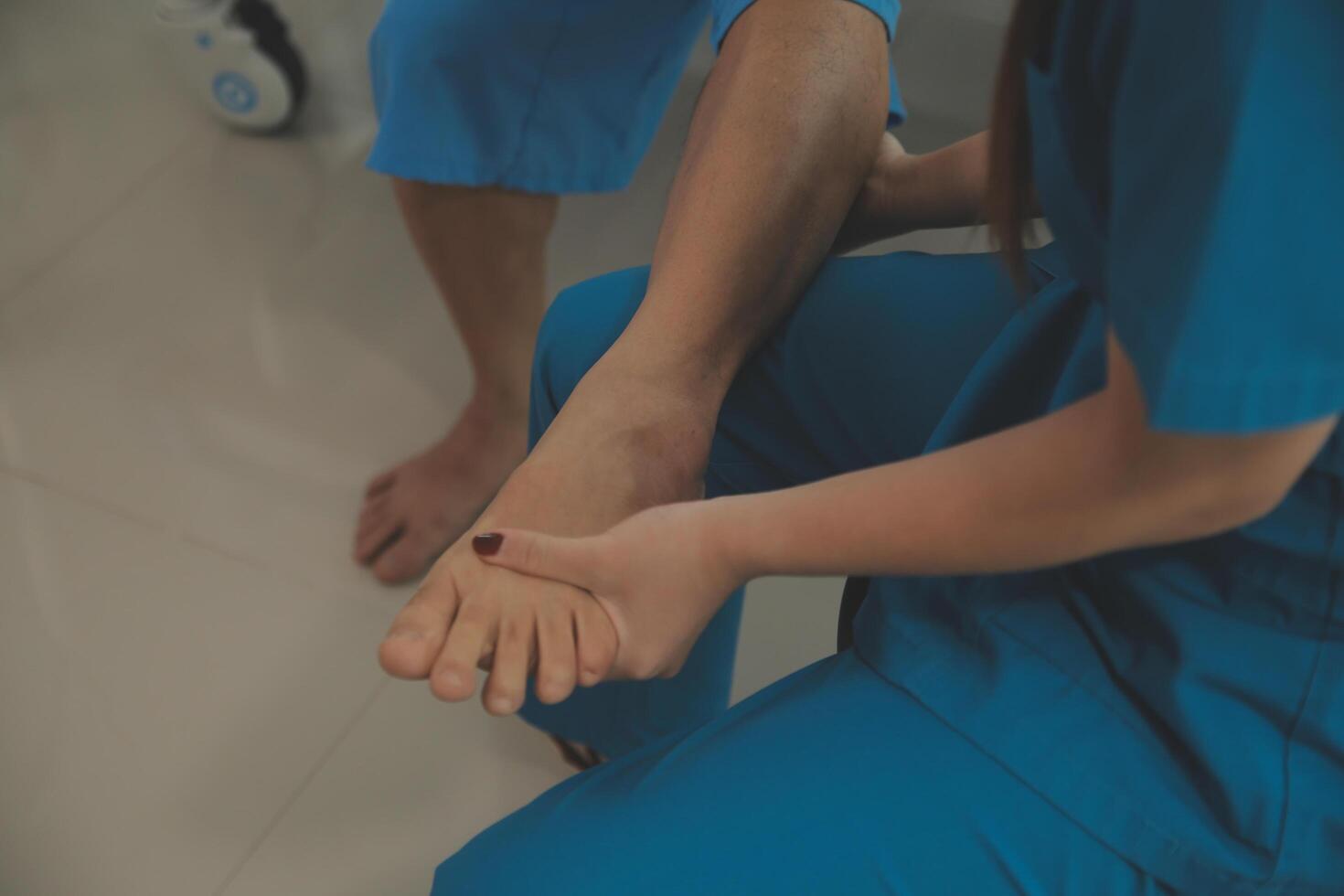 Physical therapists work with patients in close-up clinics. The concept of rehabilitation of physical health, the doctor gives advice to the patient. Ankle problems and muscle injuries photo