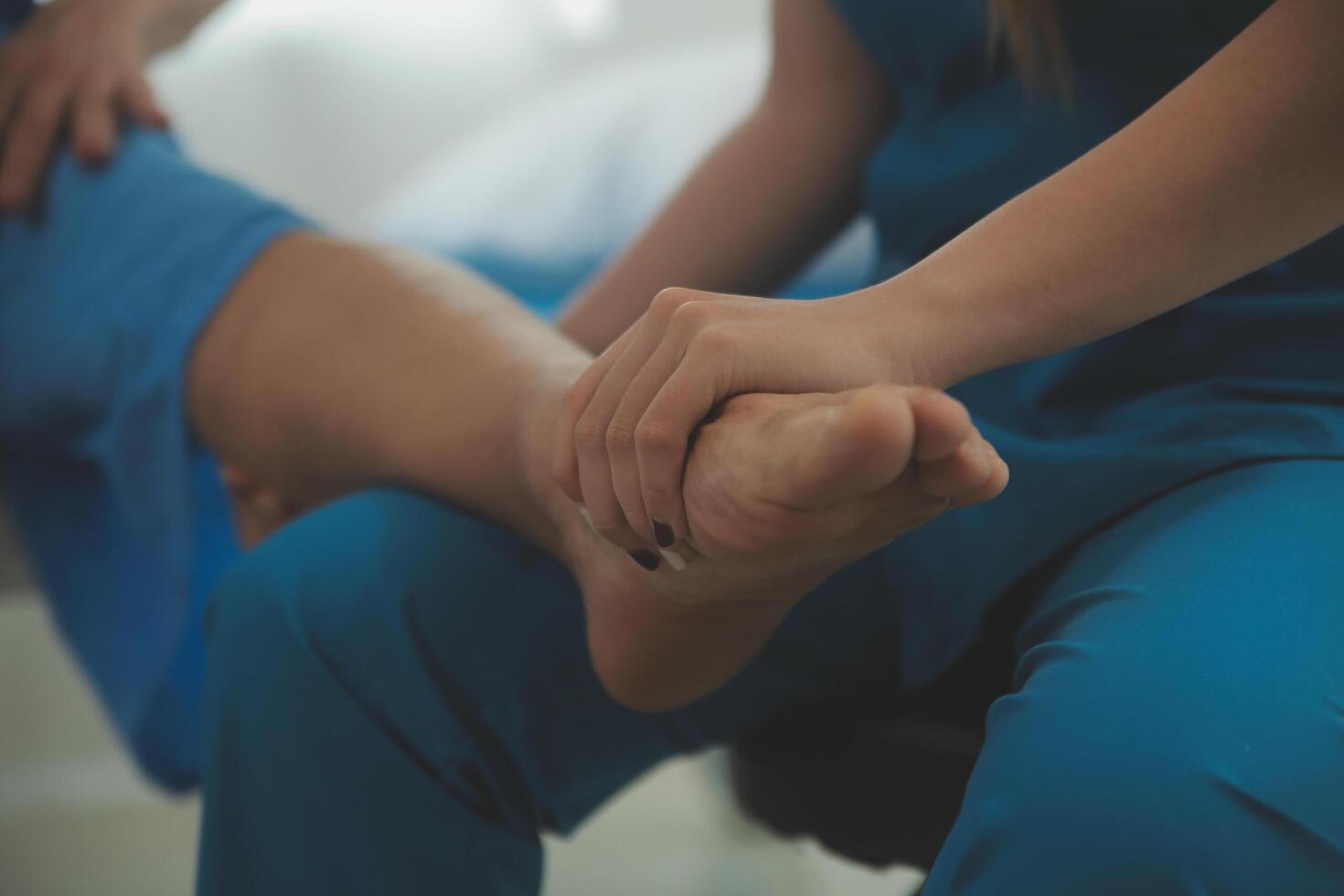 Physical therapists work with patients in close-up clinics. The concept of rehabilitation of physical health, the doctor gives advice to the patient. Ankle problems and muscle injuries photo