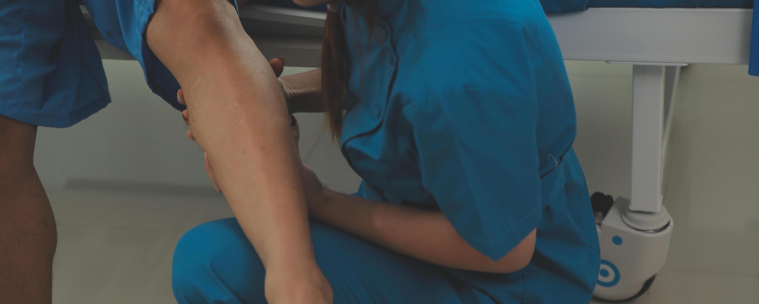 Physical therapists work with patients in close-up clinics. The concept of rehabilitation of physical health, the doctor gives advice to the patient. Ankle problems and muscle injuries photo