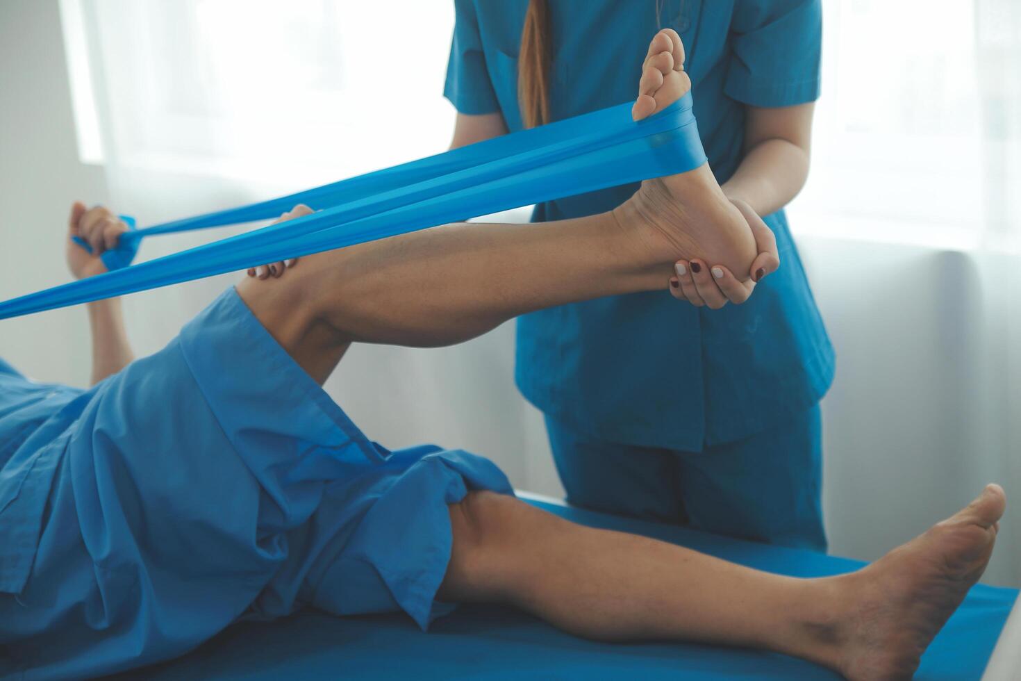 Physical therapists work with patients in close-up clinics. The concept of rehabilitation of physical health, the doctor gives advice to the patient. Ankle problems and muscle injuries photo
