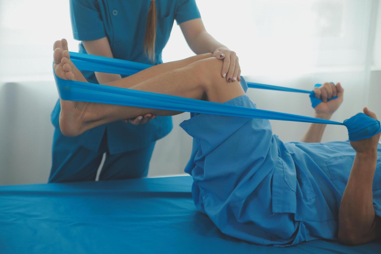 Physical therapists work with patients in close-up clinics. The concept of rehabilitation of physical health, the doctor gives advice to the patient. Ankle problems and muscle injuries photo