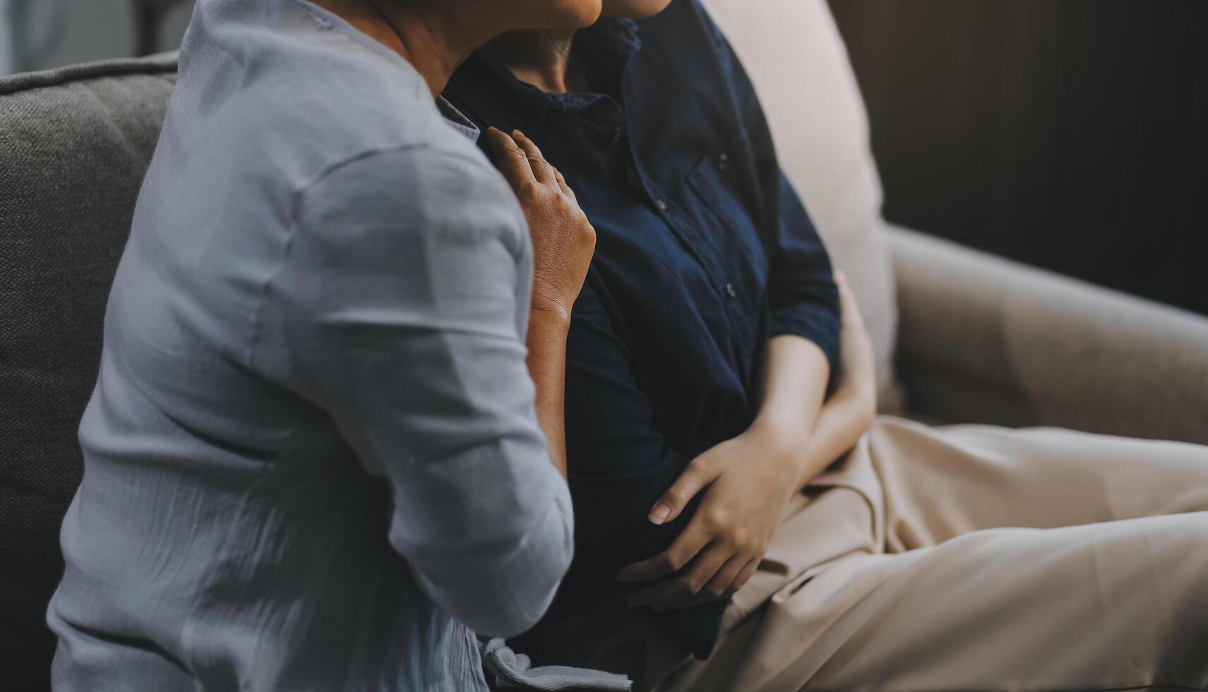 Sad teen granddaughter hugging depressed mature grandmother, giving support, help, comforting, consoling granny. Teenage daughter girl and middle aged mother going through family problems photo