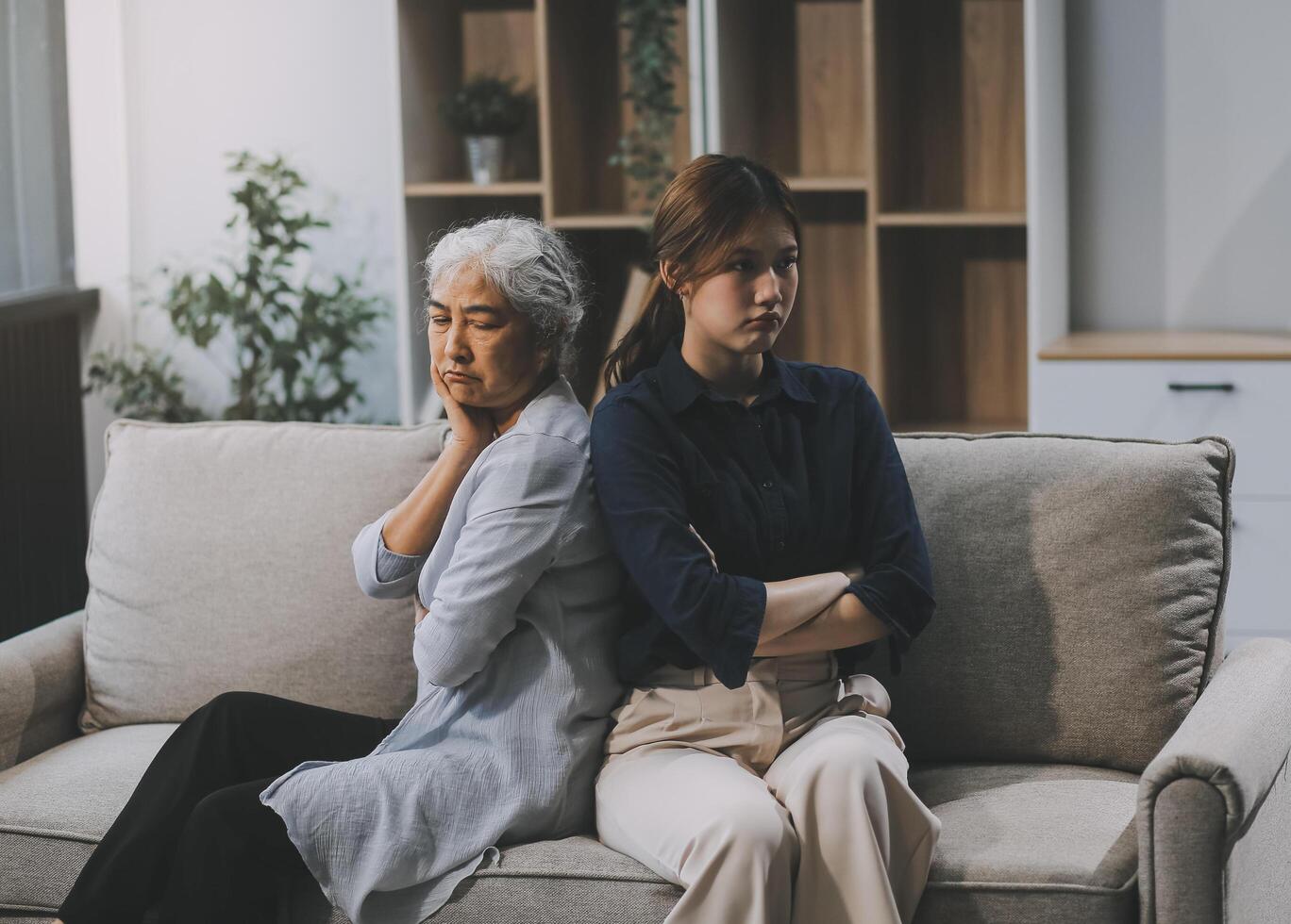 Sad teen granddaughter hugging depressed mature grandmother, giving support, help, comforting, consoling granny. Teenage daughter girl and middle aged mother going through family problems photo