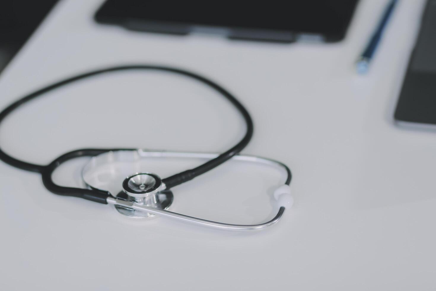 Health care billing statement with stethoscope, bottle of medicine for doctor's work in medical center stone background. photo