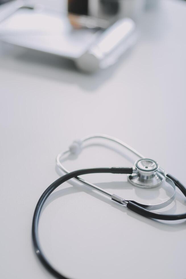 Health care billing statement with stethoscope, bottle of medicine for doctor's work in medical center stone background. photo