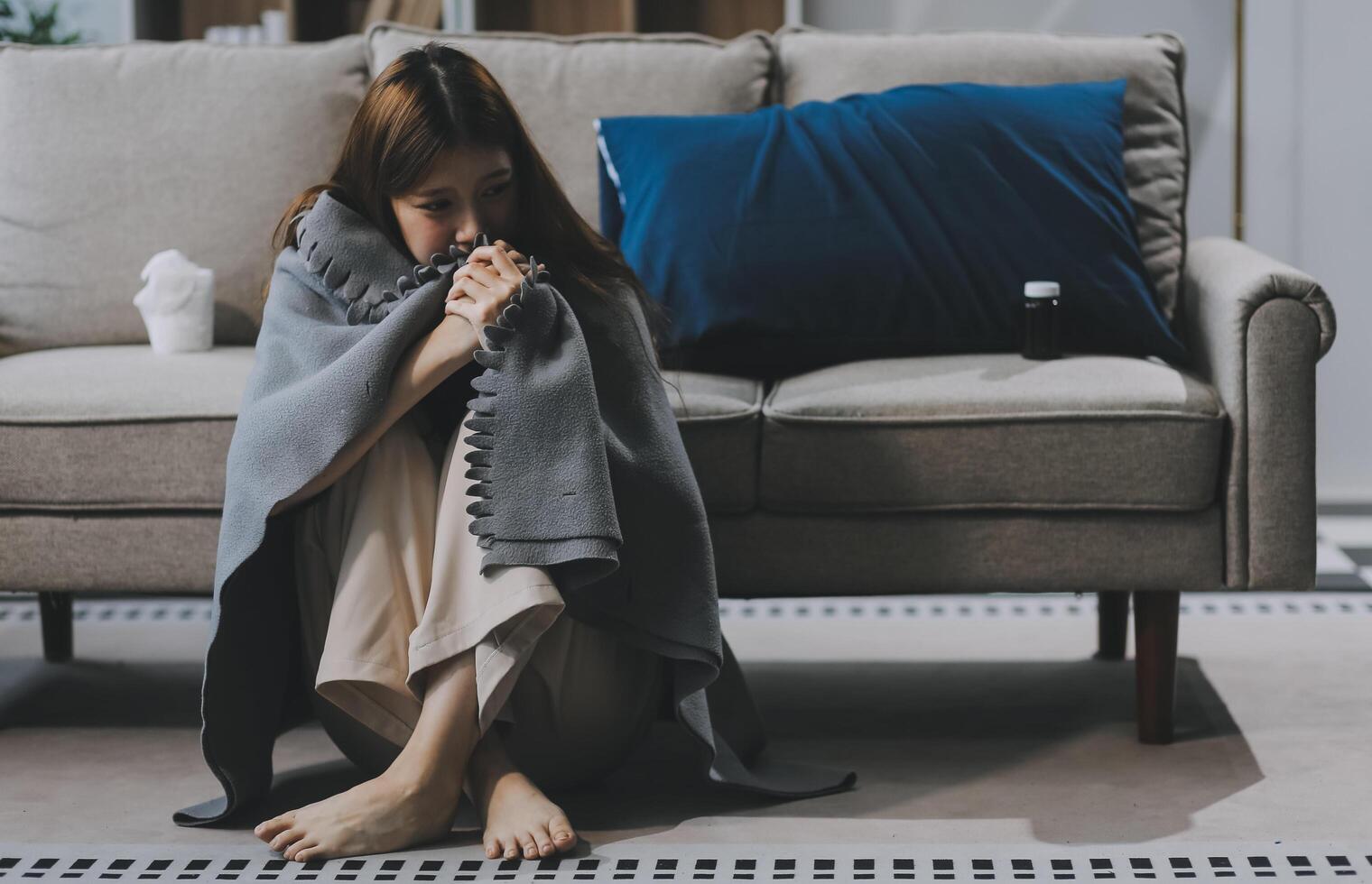 A woman with a cold with pills is treated at home chooses which drugs to take and self-medicates, checks the expiration date while sitting on the couch at home photo