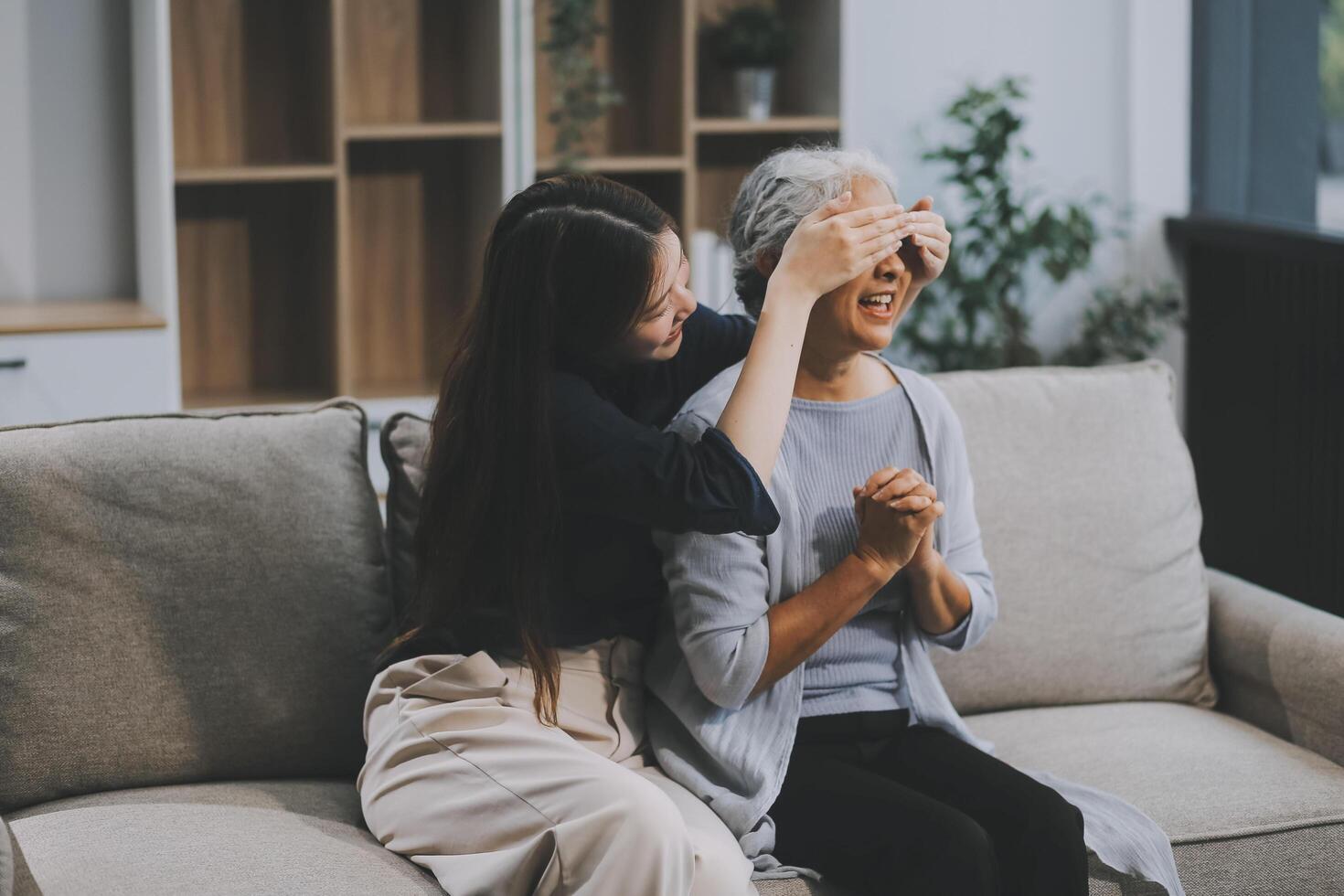 Adult daughter old mom hugging sit on couch enjoy pleasant positive talk, remembering funny occasion from life spend weekend together, caring about older generation relatives express attention concept photo