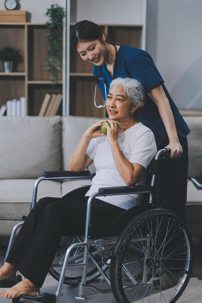 Asian physiotherapist helping elderly woman patient stretching arm during exercise correct with dumbbell in hand during training hand with patient Back problems in garden. Nursing home hospital photo
