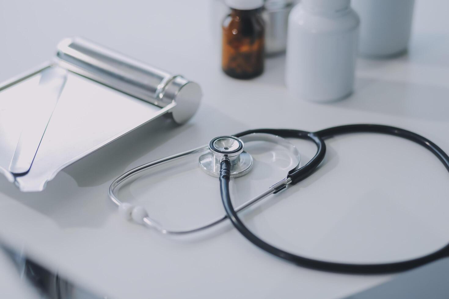 Health care billing statement with stethoscope, bottle of medicine for doctor's work in medical center stone background. photo