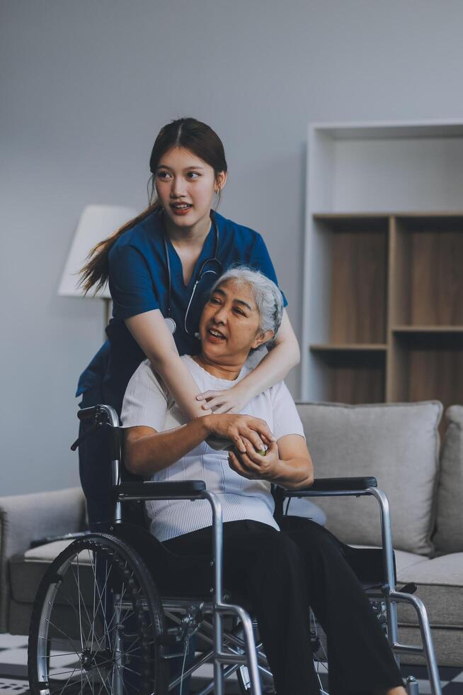 Asian physiotherapist helping elderly woman patient stretching arm during exercise correct with dumbbell in hand during training hand with patient Back problems in garden. Nursing home hospital photo