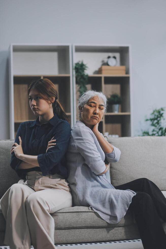 Sad teen granddaughter hugging depressed mature grandmother, giving support, help, comforting, consoling granny. Teenage daughter girl and middle aged mother going through family problems photo