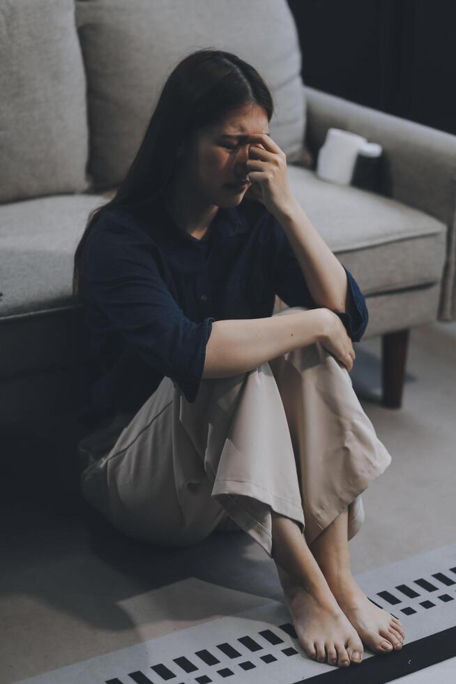 A woman with a cold with pills is treated at home chooses which drugs to take and self-medicates, checks the expiration date while sitting on the couch at home photo