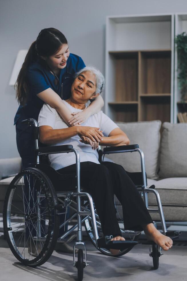 Asian physiotherapist helping elderly woman patient stretching arm during exercise correct with dumbbell in hand during training hand with patient Back problems in garden. Nursing home hospital photo