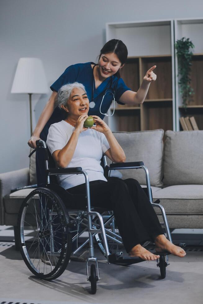 Asian physiotherapist helping elderly woman patient stretching arm during exercise correct with dumbbell in hand during training hand with patient Back problems in garden. Nursing home hospital photo