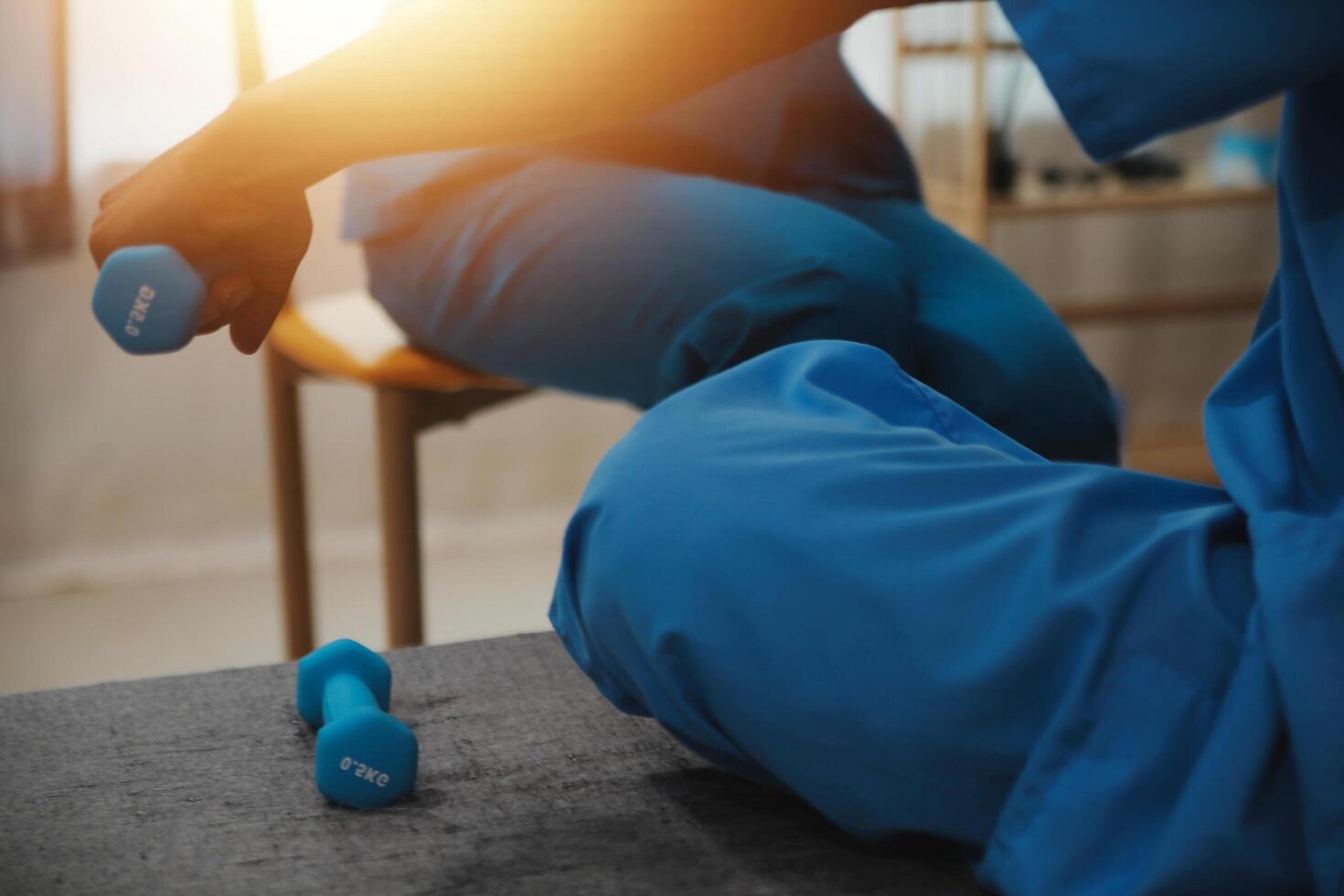Professional physical therapist examines and cares for a young man in a physical therapy center, treating muscles and injuries of a man in a hospital. photo