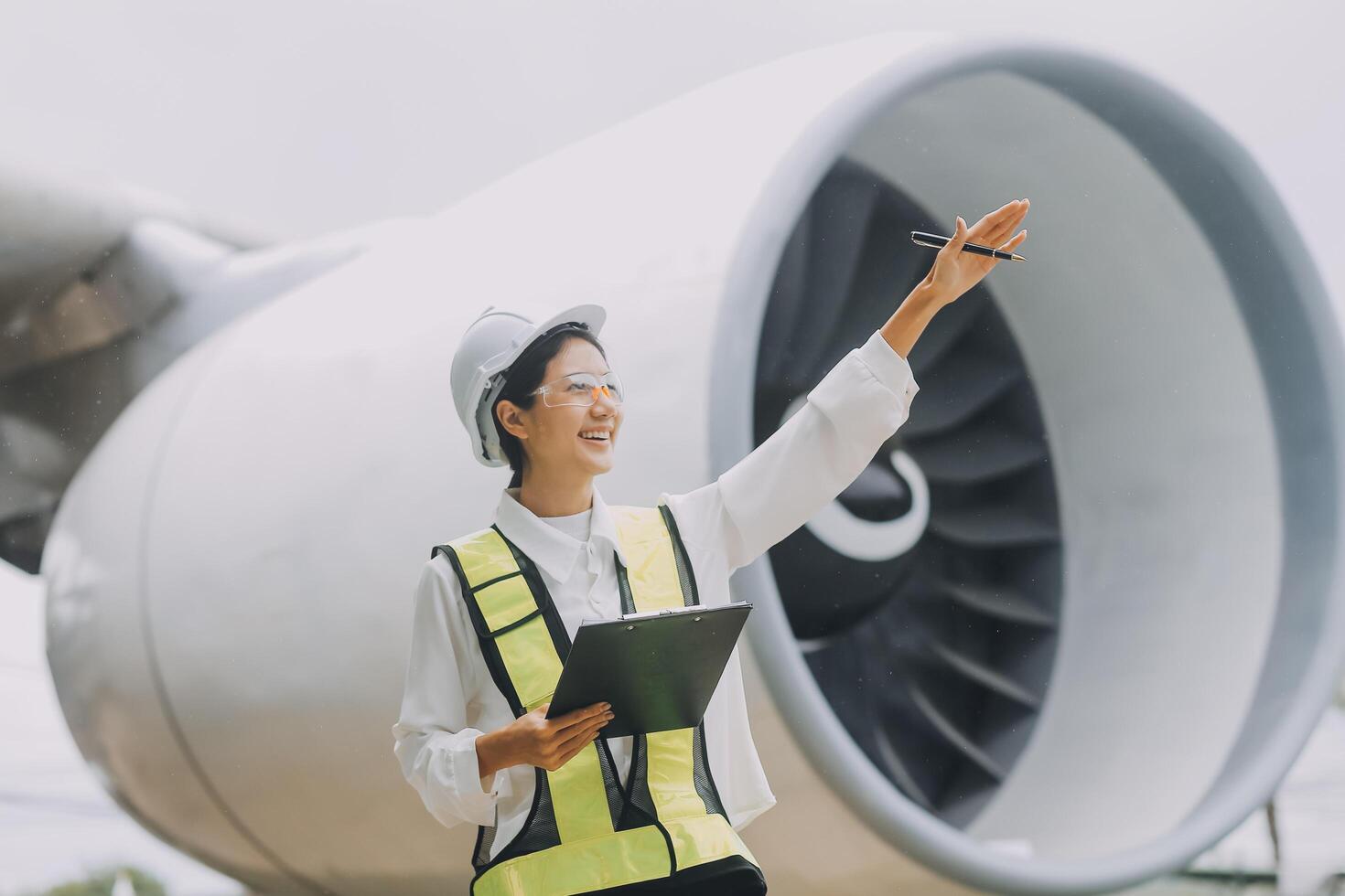 Technician fixing the engine of the airplane,Female aerospace engineering checking aircraft engines,Asian mechanic maintenance inspects plane engine photo