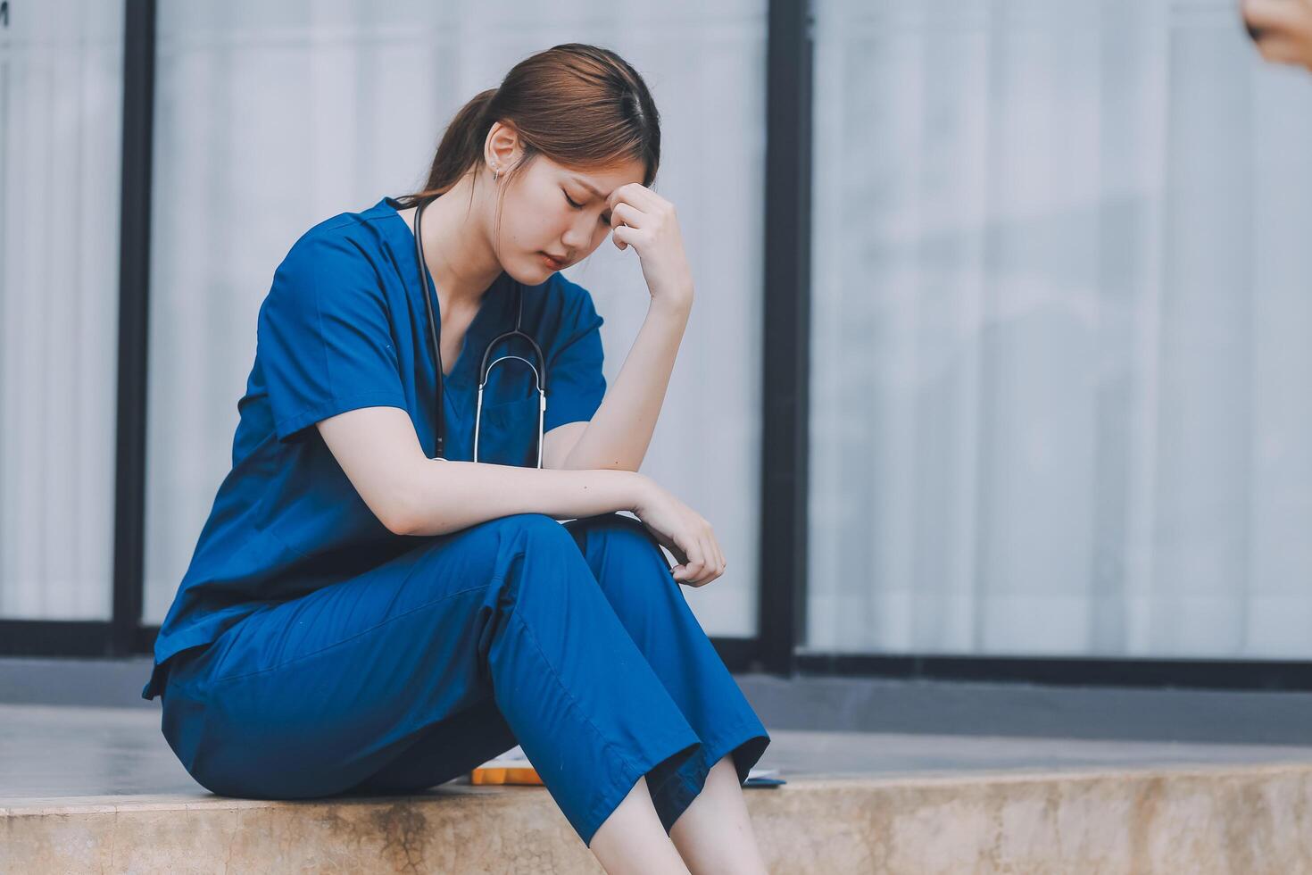 Stressed doctor sitting in front of office, working pressure. photo
