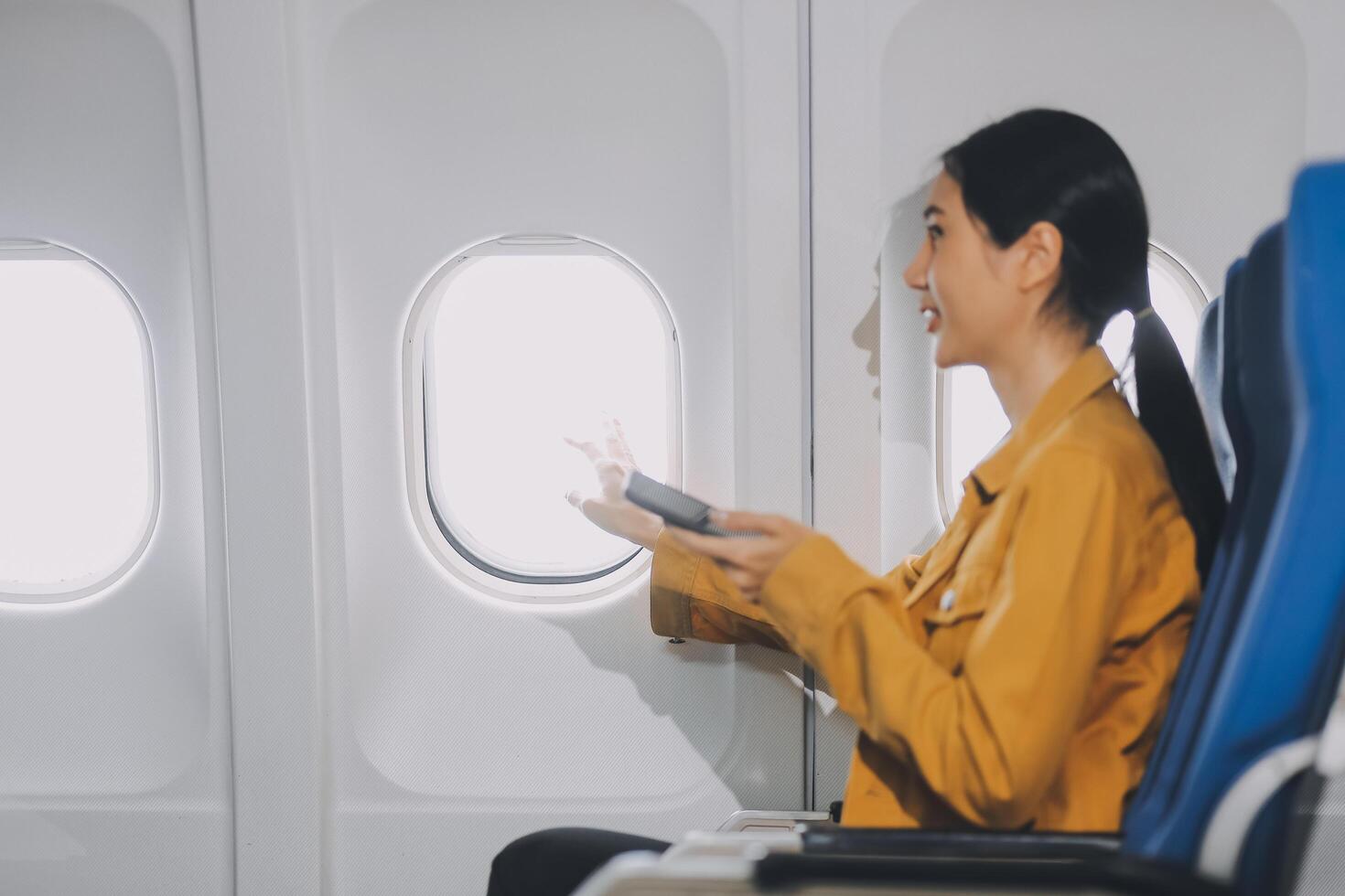 Texting on mobile chat app, Thoughtful asian people female person onboard, airplane window, perfectly capture the anticipation and excitement of holiday travel. chinese, japanese people. photo