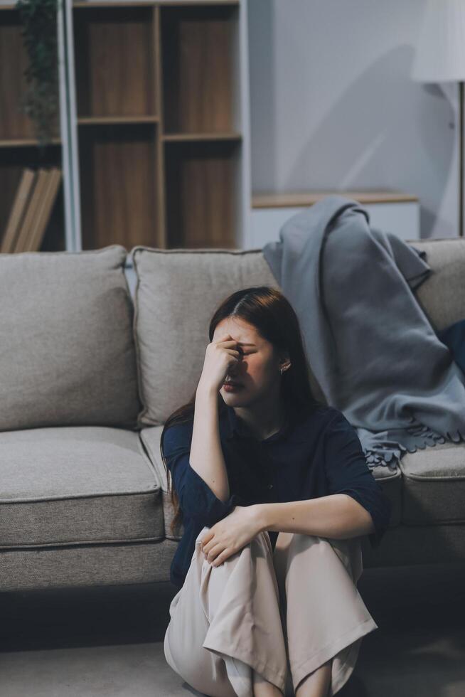 A woman with a cold with pills is treated at home chooses which drugs to take and self-medicates, checks the expiration date while sitting on the couch at home photo