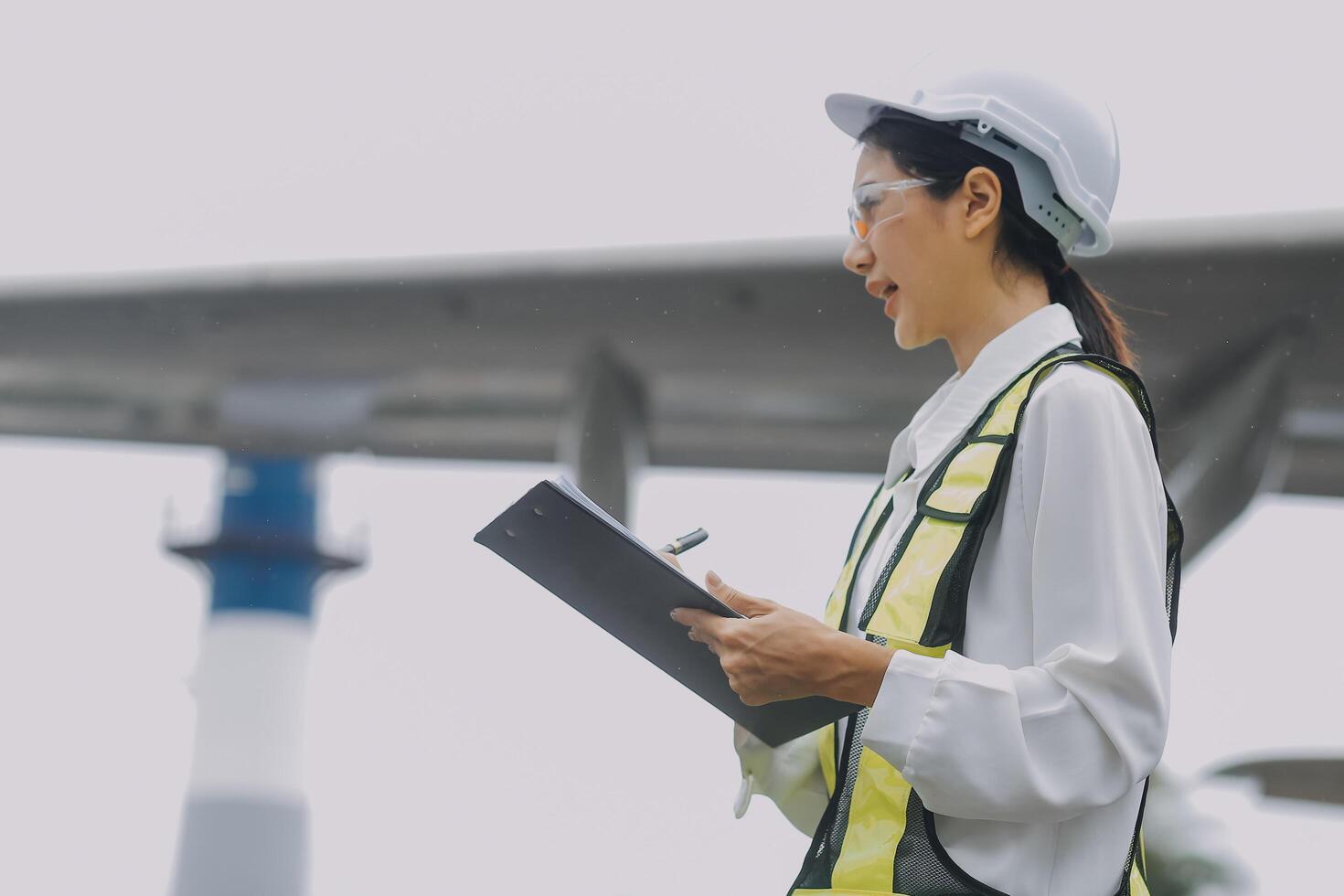 Technician fixing the engine of the airplane,Female aerospace engineering checking aircraft engines,Asian mechanic maintenance inspects plane engine photo