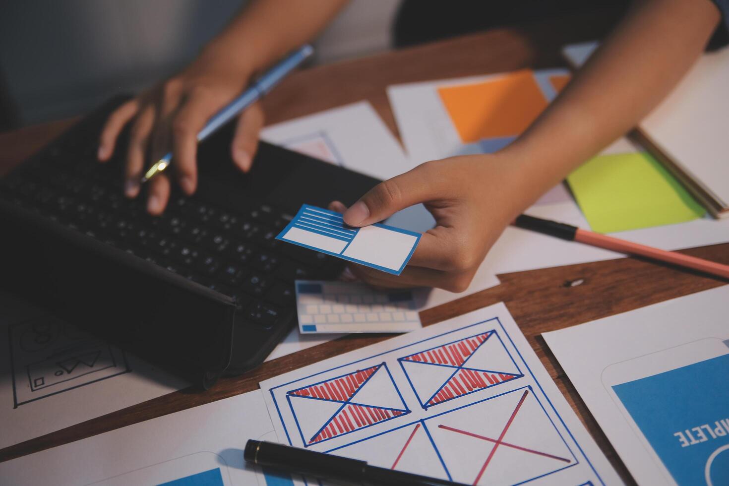 The designer team is designing the uxui system to make the uxui system work well on new phones and support system updates. Website development concept UI UX front end designer photo