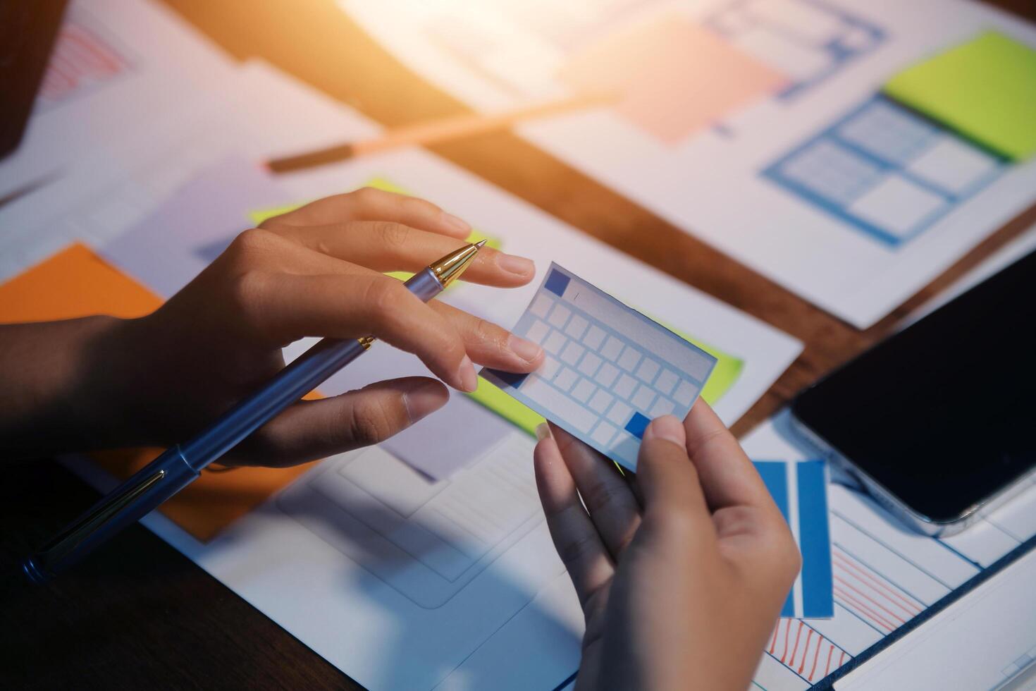 The designer team is designing the uxui system to make the uxui system work well on new phones and support system updates. Website development concept UI UX front end designer photo