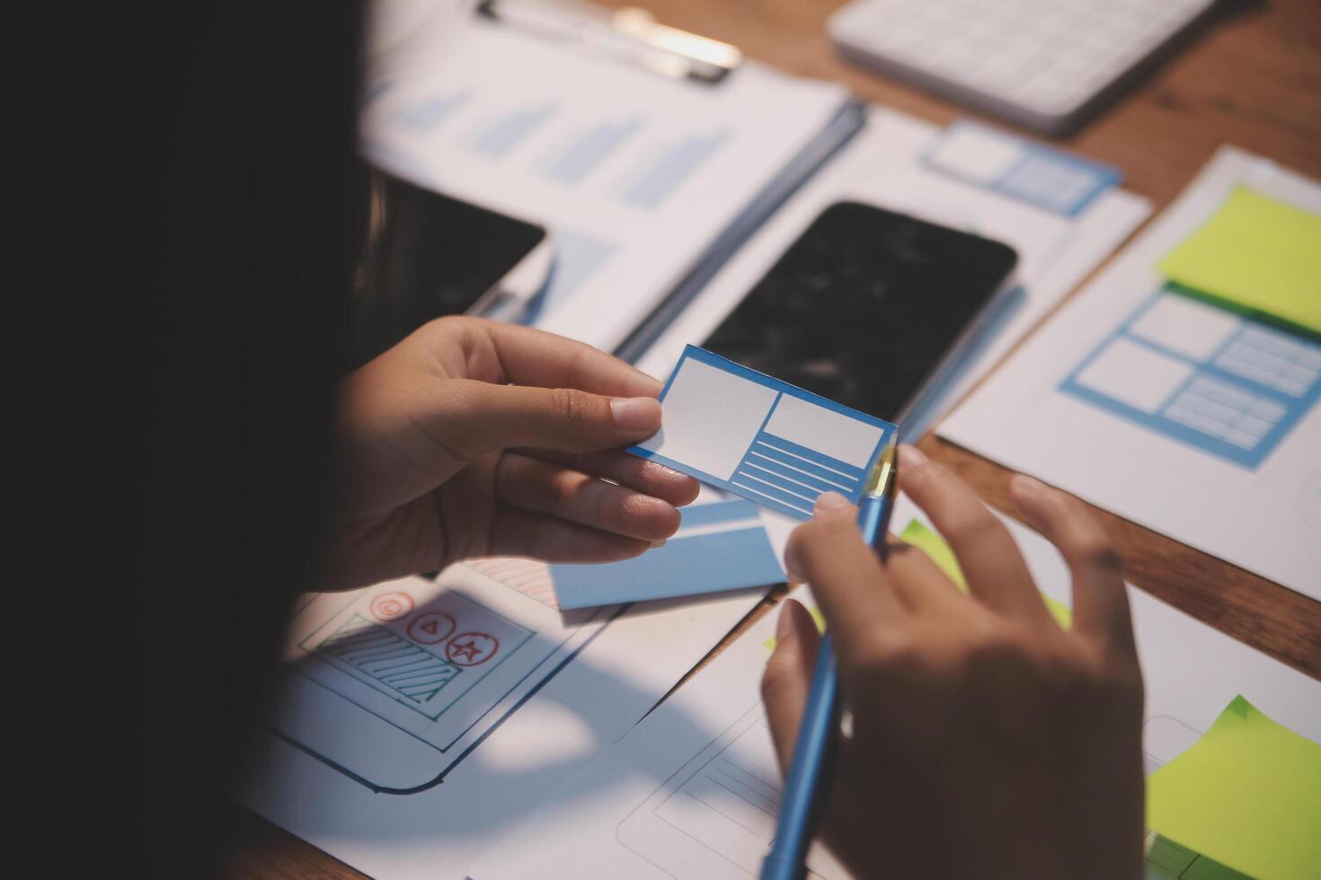 The designer team is designing the uxui system to make the uxui system work well on new phones and support system updates. Website development concept UI UX front end designer photo