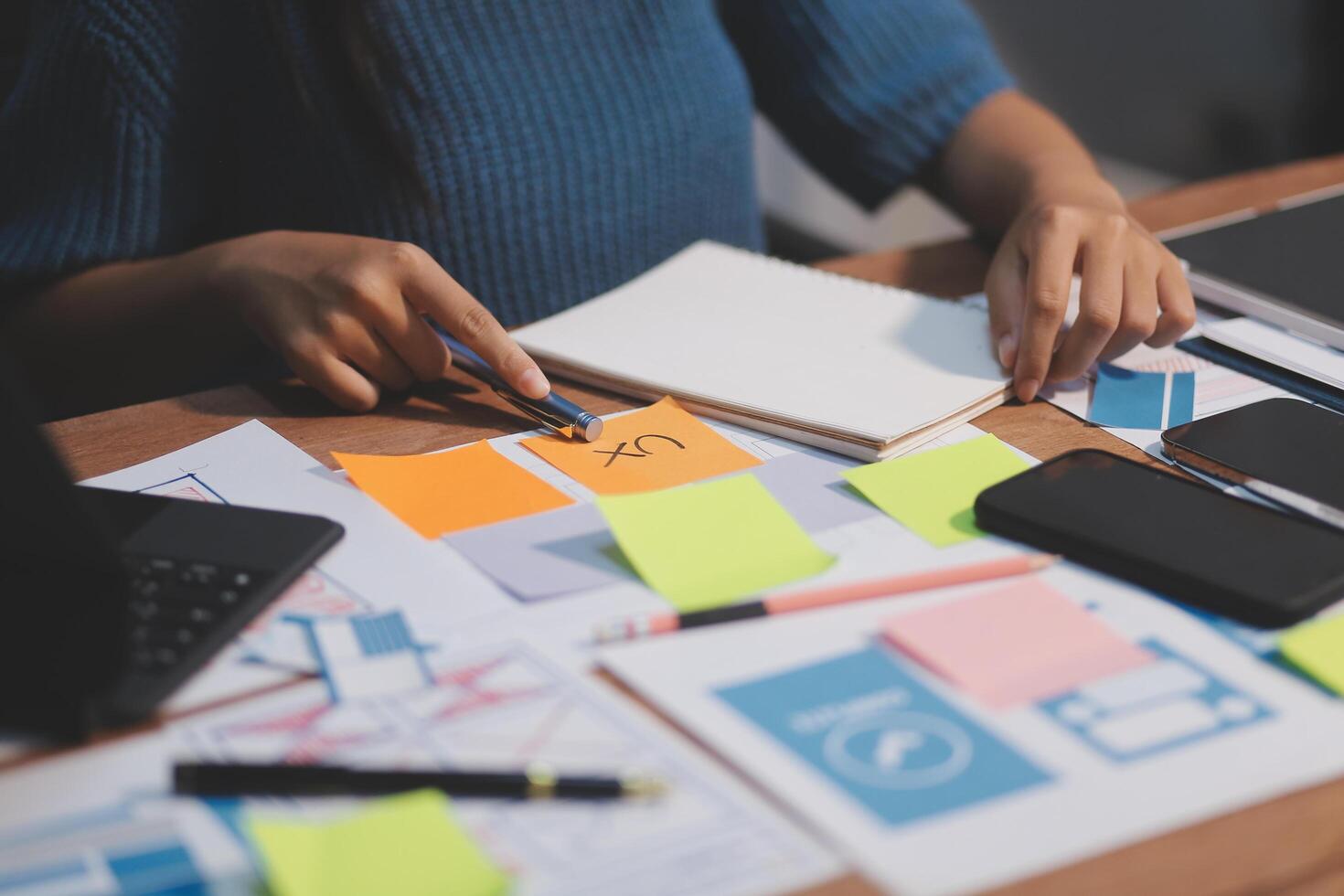 The designer team is designing the uxui system to make the uxui system work well on new phones and support system updates. Website development concept UI UX front end designer photo