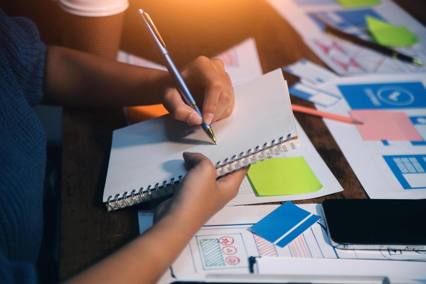 The designer team is designing the uxui system to make the uxui system work well on new phones and support system updates. Website development concept UI UX front end designer photo