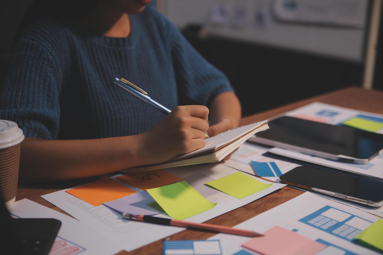 The designer team is designing the uxui system to make the uxui system work well on new phones and support system updates. Website development concept UI UX front end designer photo