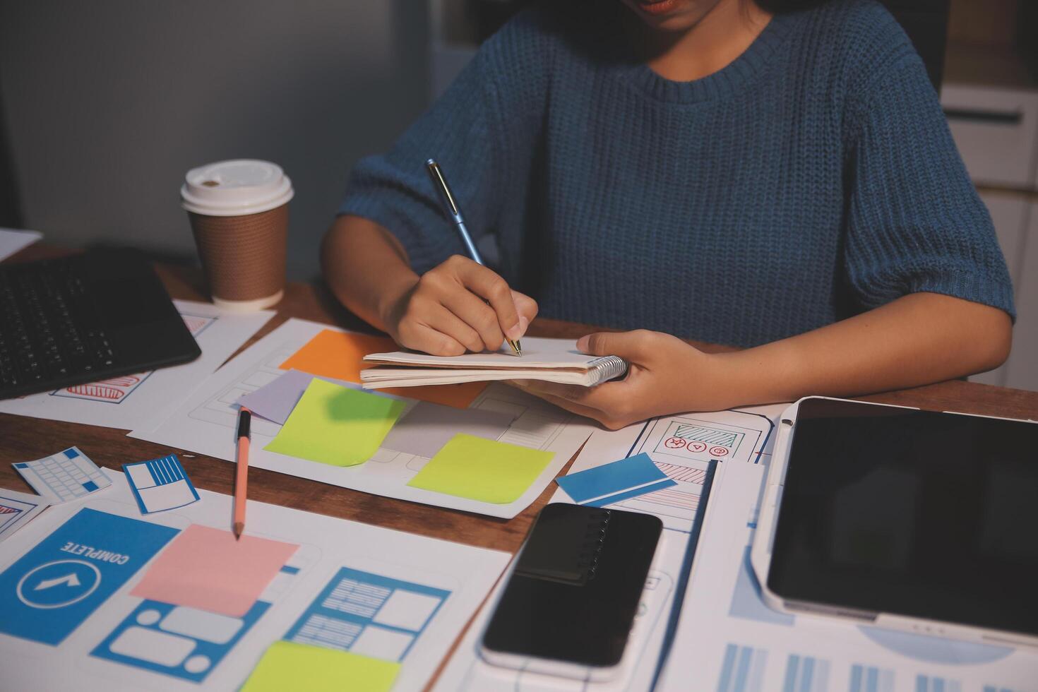 The designer team is designing the uxui system to make the uxui system work well on new phones and support system updates. Website development concept UI UX front end designer photo