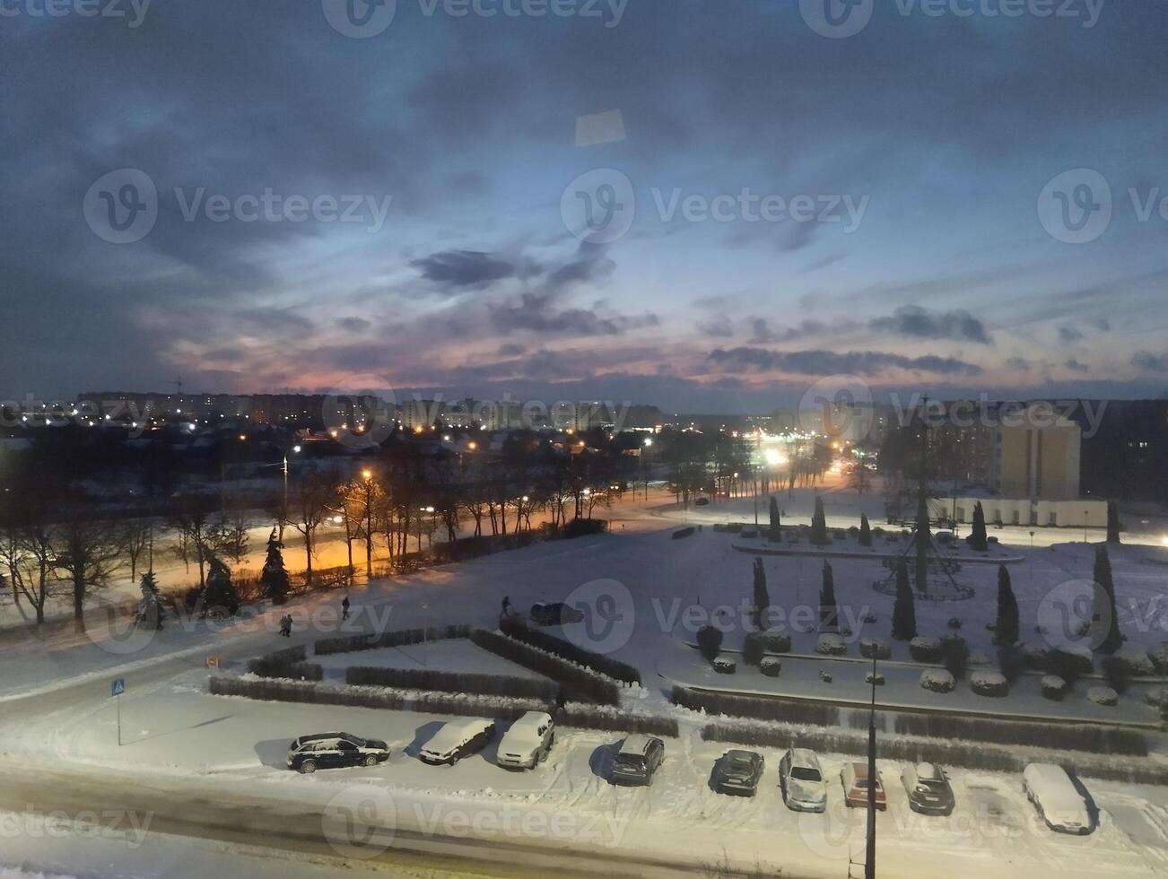 The red and blue sky over the city. Beautiful cityscapes with snow photo