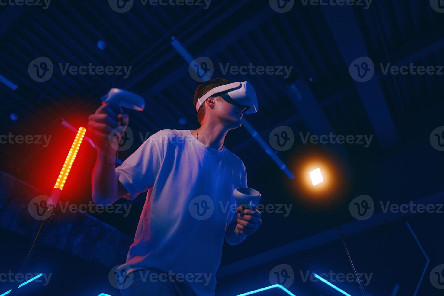 A man plays virtual reality games. VR headset and controllers. photo