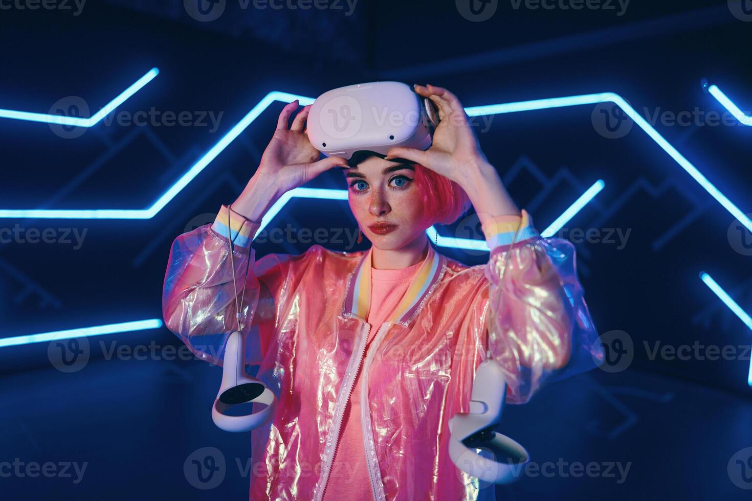 A young woman plays virtual games. Neon room for vr games. photo