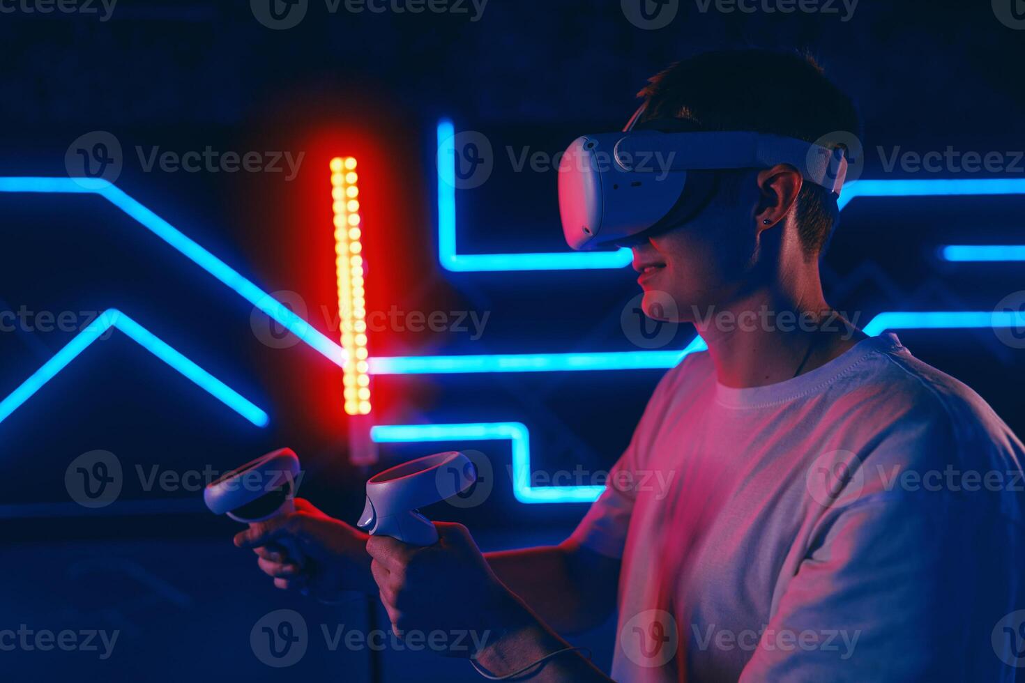 A man plays virtual reality games. VR headset and controllers. photo