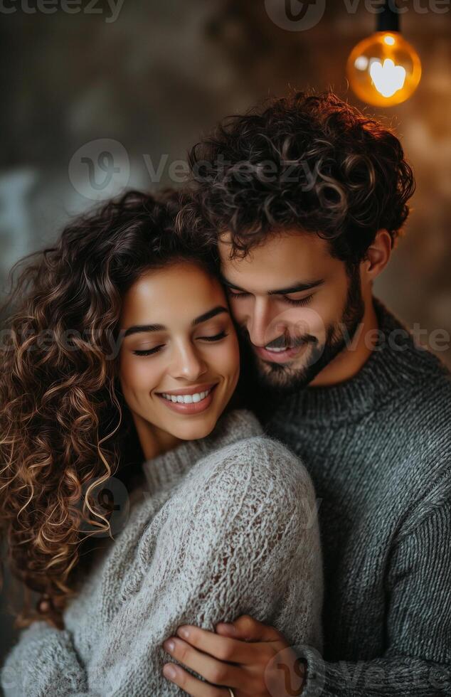 Happy couple hugging, looking at each other and smiling in a modern apartment interior photo