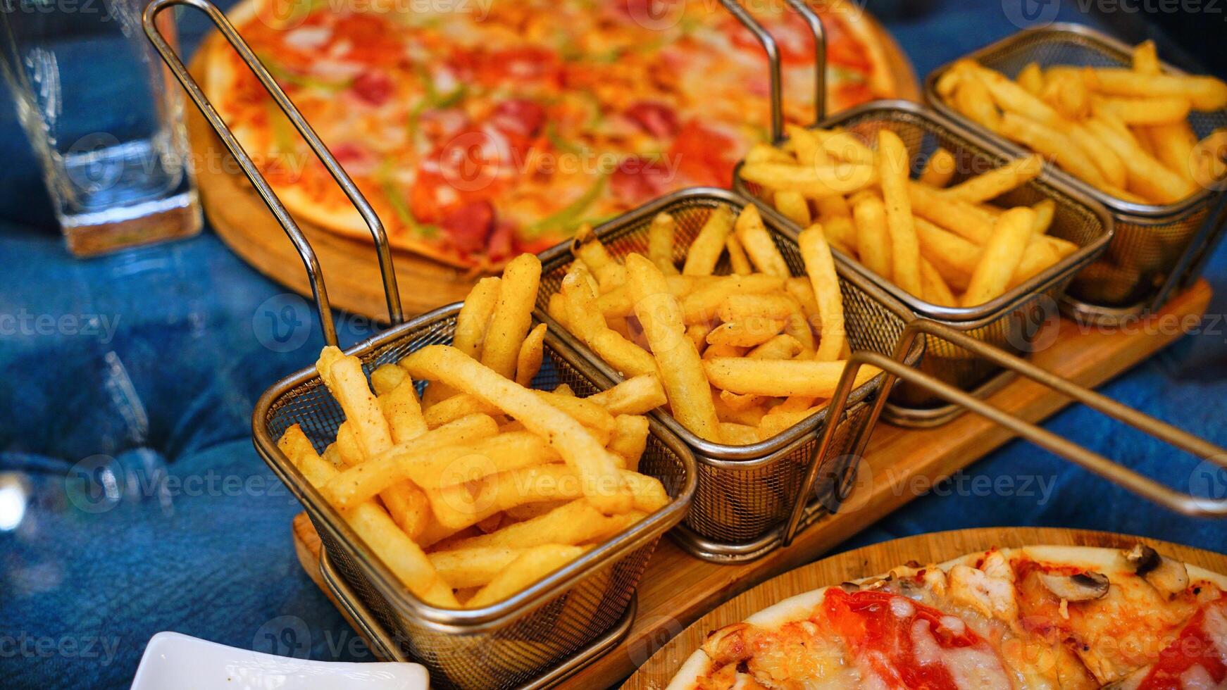 French Fries and Pizza on a Restaurant Table photo