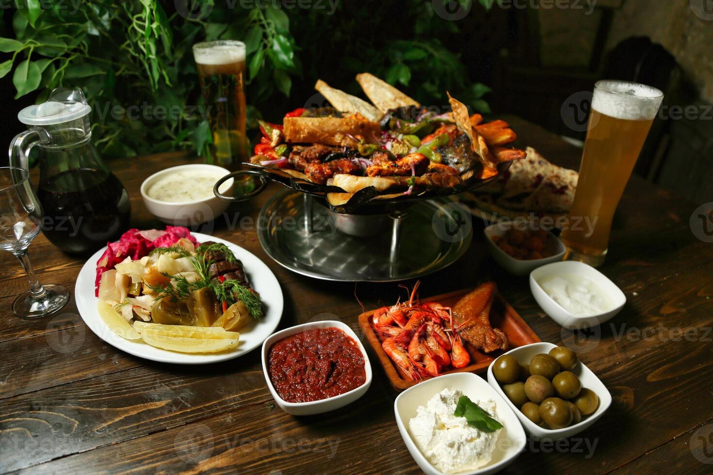 Dinner Table With Grilled Meats, Seafood, and Sides photo