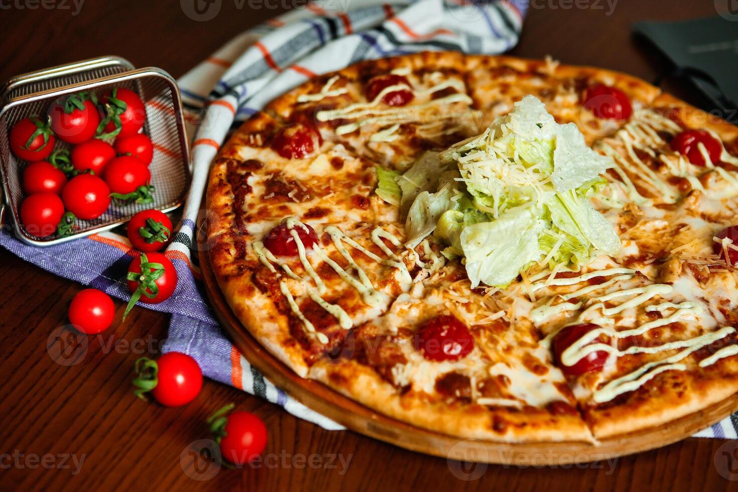Pizza With Tomatoes, Lettuce, and Drizzled Sauce photo