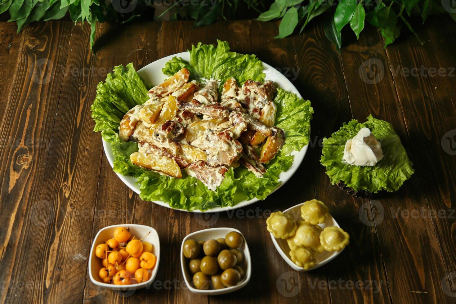 Potato and Lettuce Salad on Wooden Table photo