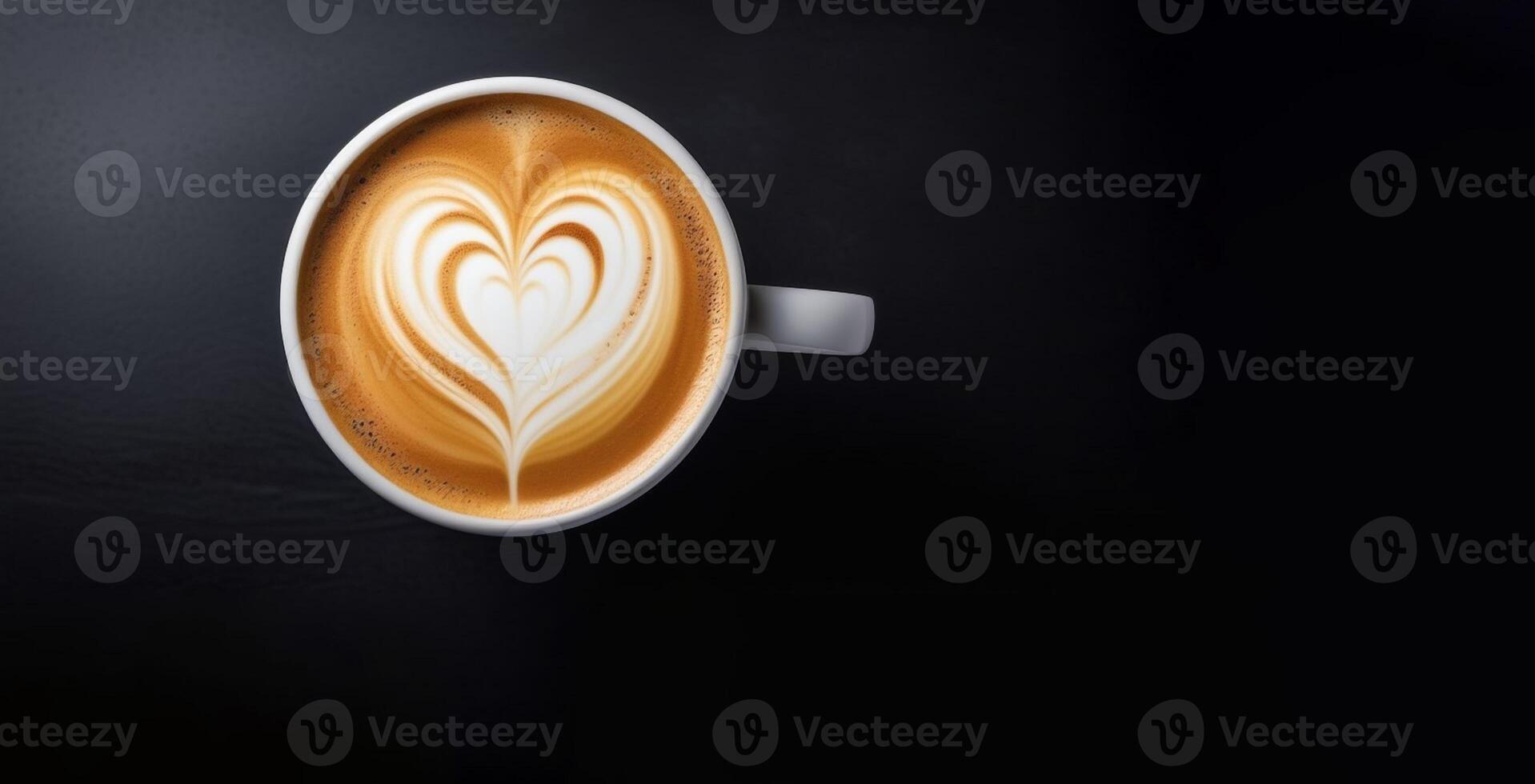 The cup of latte coffee with heart shaped latte art on dark background photo