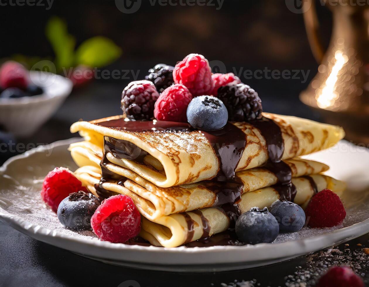 Crepes stacked with blueberries and raspberries, served with a chocolate spread photo