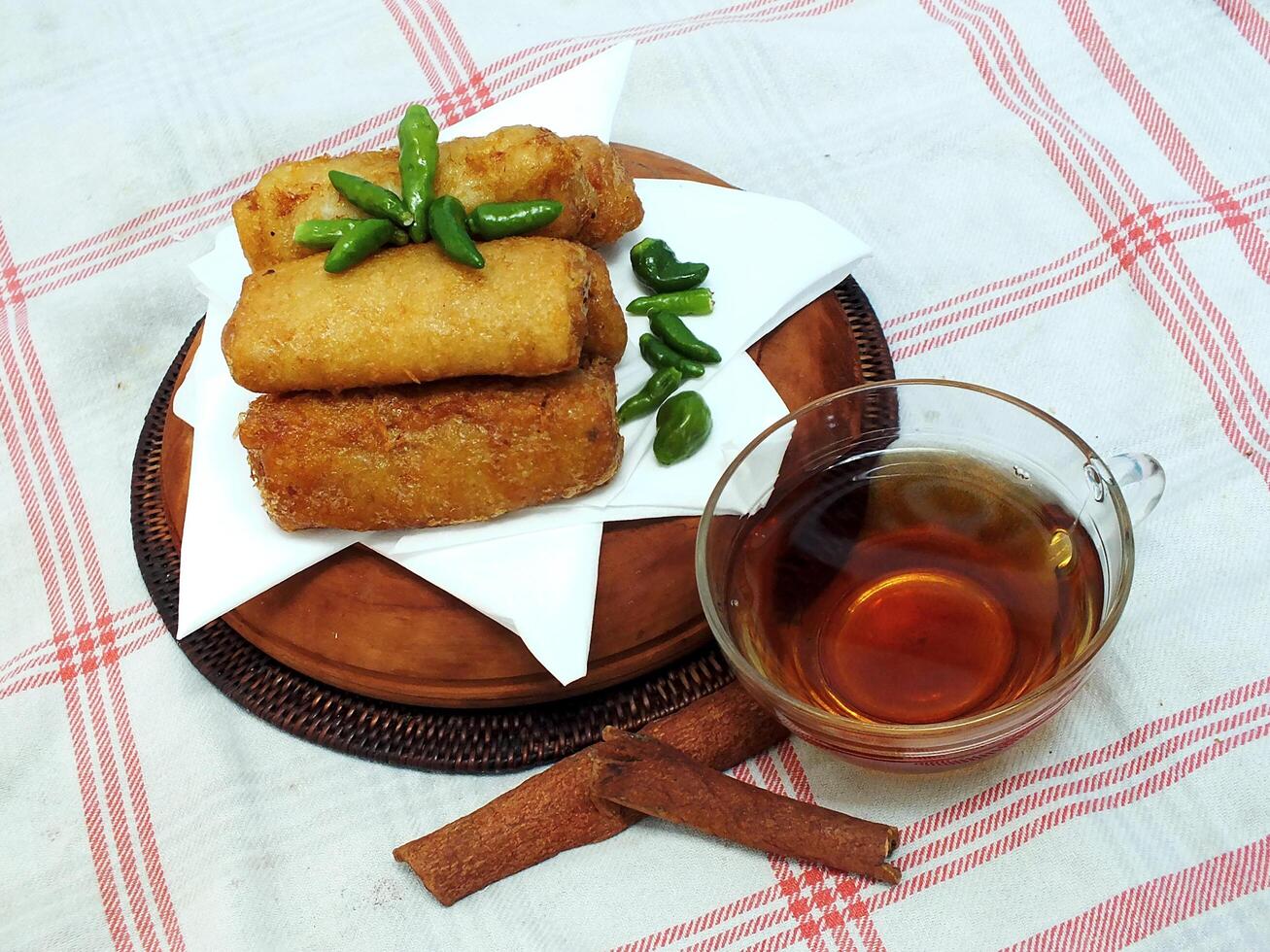 Traditional Indonesian snack Sosis Solo from Central Java, made from savory flour dough and filled with delicious minced chicken or beef then fried. More delicious if eaten with green cayenne pepper photo