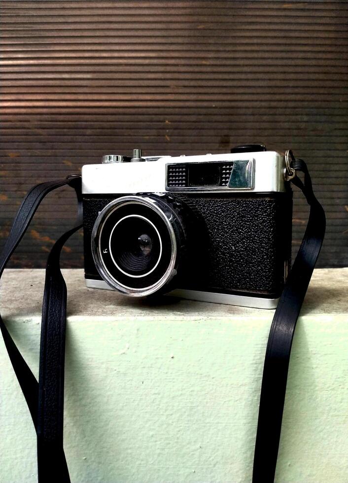 old film camera gear isolated on a dark textured background. retro photography vintage. nostalgic vacation historical moment photo