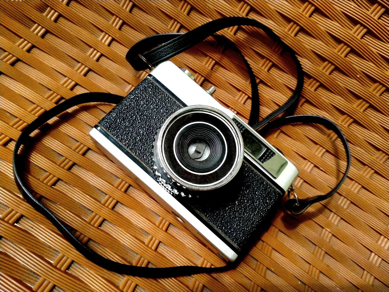 Old film camera gear isolated on a brown textured background. retro photography vintage. nostalgic vacation historical moment photo