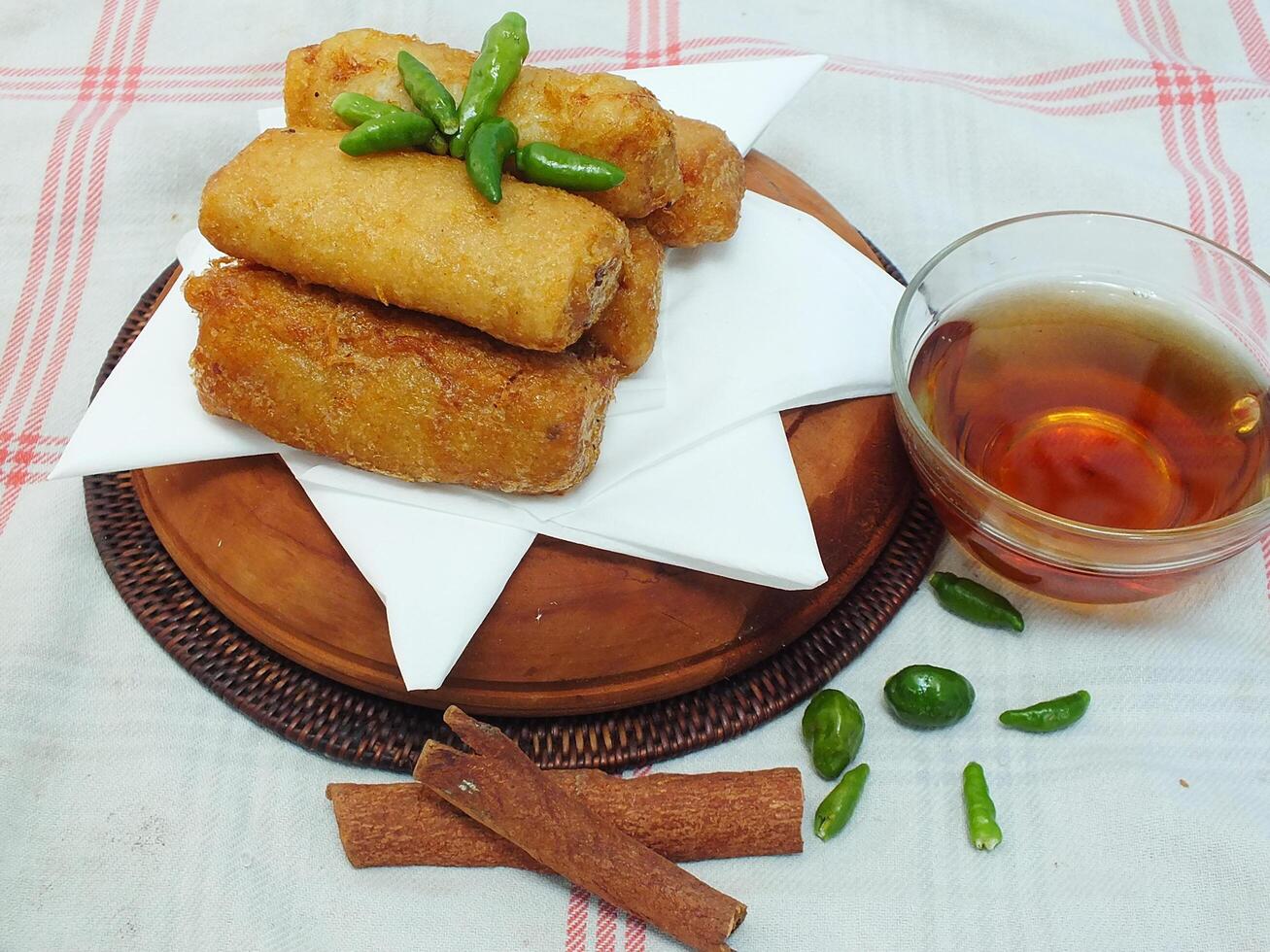 Traditional Indonesian snack Sosis Solo from Central Java, made from savory flour dough and filled with delicious minced chicken or beef then fried. More delicious if eaten with green cayenne pepper photo